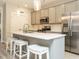 Modern kitchen with gray cabinets, stainless steel appliances, and a large island with seating at 1517 Millrock Trl, Wendell, NC 27591