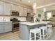 Stylish kitchen featuring gray cabinets, stainless steel appliances, and island seating at 1517 Millrock Trl, Wendell, NC 27591