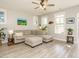 Bright living room featuring a comfortable sectional sofa and light wood flooring at 1517 Millrock Trl, Wendell, NC 27591