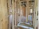 Unfinished bathroom featuring new construction framing, rough plumbing, and a shower base at 152 Cultivator Ct, Angier, NC 27501
