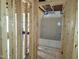Unfinished bathroom featuring exposed framing and a new bathtub with surround at 152 Cultivator Ct, Angier, NC 27501