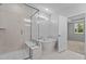 Bright bathroom featuring a standalone tub, tiled shower with bench, and an open doorway to the bedroom at 152 Cultivator Ct, Angier, NC 27501