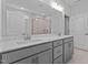Modern bathroom with dual sink vanity, framed mirror, and tiled shower with glass doors at 152 Cultivator Ct, Angier, NC 27501