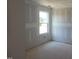 A bright and airy room with neutral walls and a large window at 152 Cultivator Ct, Angier, NC 27501
