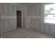 Bright bedroom with a window for natural light and a door leading to an adjacent room at 152 Cultivator Ct, Angier, NC 27501