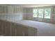Spacious bonus room is prepped for flooring and finishing, with large windows for plenty of natural light at 152 Cultivator Ct, Angier, NC 27501
