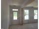 Bright entryway featuring a classic door with glass panes and adjacent window views at 152 Cultivator Ct, Angier, NC 27501