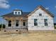 New construction home featuring brick facade and protective house wrap in a residential neighborhood at 152 Cultivator Ct, Angier, NC 27501