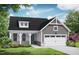 Charming home featuring a gray exterior, inviting front porch, and a two-car garage at 152 Cultivator Ct, Angier, NC 27501