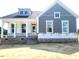 Charming two-story new home with a covered porch and modern gray siding at 152 Cultivator Ct, Angier, NC 27501