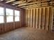 Unfinished living room showcasing new construction framing, abundant natural light, and bare plywood subfloors at 152 Cultivator Ct, Angier, NC 27501
