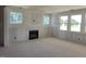 Bright living room space with a cozy fireplace and plenty of natural light from large windows at 152 Cultivator Ct, Angier, NC 27501