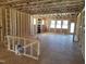 Unfinished living room framing, featuring new construction, large windows, and natural light at 152 Cultivator Ct, Angier, NC 27501