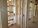 Unfinished room framing displaying new construction plumbing and electrical wiring throughout the space at 152 Cultivator Ct, Angier, NC 27501