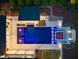 Aerial view of a luxury home with a pool, spa, patio, and outdoor kitchen area at twilight at 1616 Hunting Ridge Rd, Raleigh, NC 27615