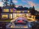 A luxury backyard featuring a stunning pool, jacuzzi, and outdoor kitchen, perfect for entertaining friends and Gathering at 1616 Hunting Ridge Rd, Raleigh, NC 27615