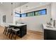Stylish bar area with counter seating, modern lighting, and serene window view at 1616 Hunting Ridge Rd, Raleigh, NC 27615