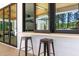 Stylish outdoor bar with stools and pass-through windows to the interior at 1616 Hunting Ridge Rd, Raleigh, NC 27615