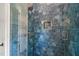 Modern shower with beautiful blue tile, niche for storage, and glass door at 1616 Hunting Ridge Rd, Raleigh, NC 27615