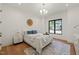Bright bedroom with hardwood floors, stylish rug, and large window overlooking the trees at 1616 Hunting Ridge Rd, Raleigh, NC 27615
