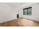 Bright bedroom featuring light hardwood floors, neutral walls, a modern ceiling fan, and a window with natural light at 1616 Hunting Ridge Rd, Raleigh, NC 27615