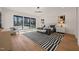 Spacious bedroom features hardwood flooring, accent rug, and multiple windows looking at landscape at 1616 Hunting Ridge Rd, Raleigh, NC 27615