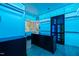 Modern walk-in closet with unique blue lighting, custom cabinetry and shelving at 1616 Hunting Ridge Rd, Raleigh, NC 27615