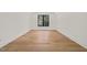 Bright and spacious empty room with beautiful hardwood floors, neutral walls, and a large window with natural light at 1616 Hunting Ridge Rd, Raleigh, NC 27615