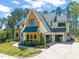 Attractive two-story home showcasing modern architecture, a pristine lawn, a two-car garage and meticulously landscaped grounds at 1616 Hunting Ridge Rd, Raleigh, NC 27615