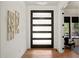 Stylish foyer with hardwood floors, modern lighting, and decorative wall art, creating an inviting entrance at 1616 Hunting Ridge Rd, Raleigh, NC 27615