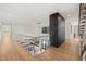 Open-concept foyer with glass railings overlooking the living room, dining area and kitchen at 1616 Hunting Ridge Rd, Raleigh, NC 27615