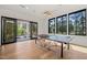 Bright game room showcasing a ping pong table, sleek lighting, and outdoor access at 1616 Hunting Ridge Rd, Raleigh, NC 27615