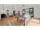 Spacious game room featuring a ping pong table, modern lighting, and open living area at 1616 Hunting Ridge Rd, Raleigh, NC 27615