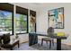 Stylish home office featuring a unique stone desk, modern art, and view of outdoors at 1616 Hunting Ridge Rd, Raleigh, NC 27615