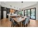 Eat-in kitchen with island, modern lighting, and direct access to patio at 1616 Hunting Ridge Rd, Raleigh, NC 27615