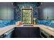 Stylish kitchen with blue cabinetry, patterned backsplash, quartz countertops, and stainless sink at 1616 Hunting Ridge Rd, Raleigh, NC 27615