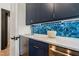 Kitchen featuring blue cabinetry, stainless steel appliances, quartz countertops, and modern fixtures at 1616 Hunting Ridge Rd, Raleigh, NC 27615