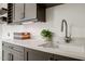 Laundry room with gray cabinets, stainless steel sink, and white countertop at 1616 Hunting Ridge Rd, Raleigh, NC 27615