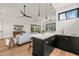 Open-concept living room with modern furnishings, sleek ceiling fan, bar and natural light at 1616 Hunting Ridge Rd, Raleigh, NC 27615