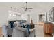 Open-concept living room with a modern design, stylish furniture, a ping-pong table, and a wet bar at 1616 Hunting Ridge Rd, Raleigh, NC 27615