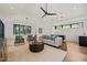 Living room with a modern sofa, oversized windows, a ping-pong table, and a wet bar at 1616 Hunting Ridge Rd, Raleigh, NC 27615
