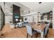 Open-concept living area with fireplace, dining, and kitchen; light wood floors at 1616 Hunting Ridge Rd, Raleigh, NC 27615