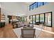 Open-concept living space with soaring ceilings, modern decor, and outdoor views at 1616 Hunting Ridge Rd, Raleigh, NC 27615