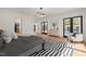 Spacious primary bedroom featuring wood floors, a black and white rug, and backyard access at 1616 Hunting Ridge Rd, Raleigh, NC 27615