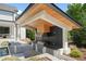 Outdoor kitchen with stainless steel grill, granite counters, and wood accents near the pool at 1616 Hunting Ridge Rd, Raleigh, NC 27615