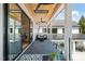 Covered patio area with comfortable seating, a ceiling fan, and views of the property at 1616 Hunting Ridge Rd, Raleigh, NC 27615