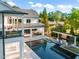 Areal view of the rear of the house, featuring a large pool and outdoor entertaining area at 1616 Hunting Ridge Rd, Raleigh, NC 27615