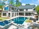 Expansive back exterior with pool, hot tub, patio, balconies, and outdoor seating areas, perfect for entertaining at 1616 Hunting Ridge Rd, Raleigh, NC 27615