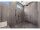 Modern shower with sleek black fixtures, multiple shower heads, and built in bench at 1616 Hunting Ridge Rd, Raleigh, NC 27615