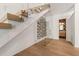 A modern staircase with glass railings and a wall-mounted wine rack in an entryway at 1616 Hunting Ridge Rd, Raleigh, NC 27615